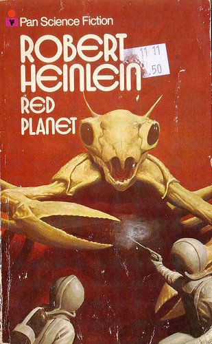 Red Planet front cover showing two men in astronaut like suits with one wielding a pistol against a giant ant-like creature coming towards them with huge pincers